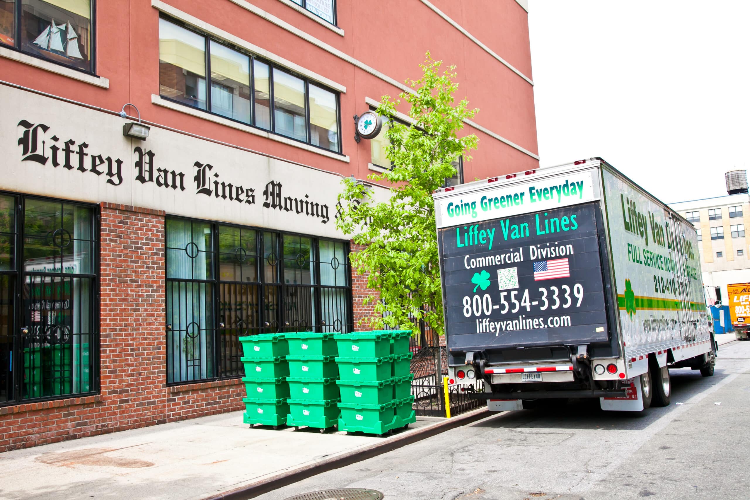 Trucks packed and ready with moving boxes outside NYC residential complex