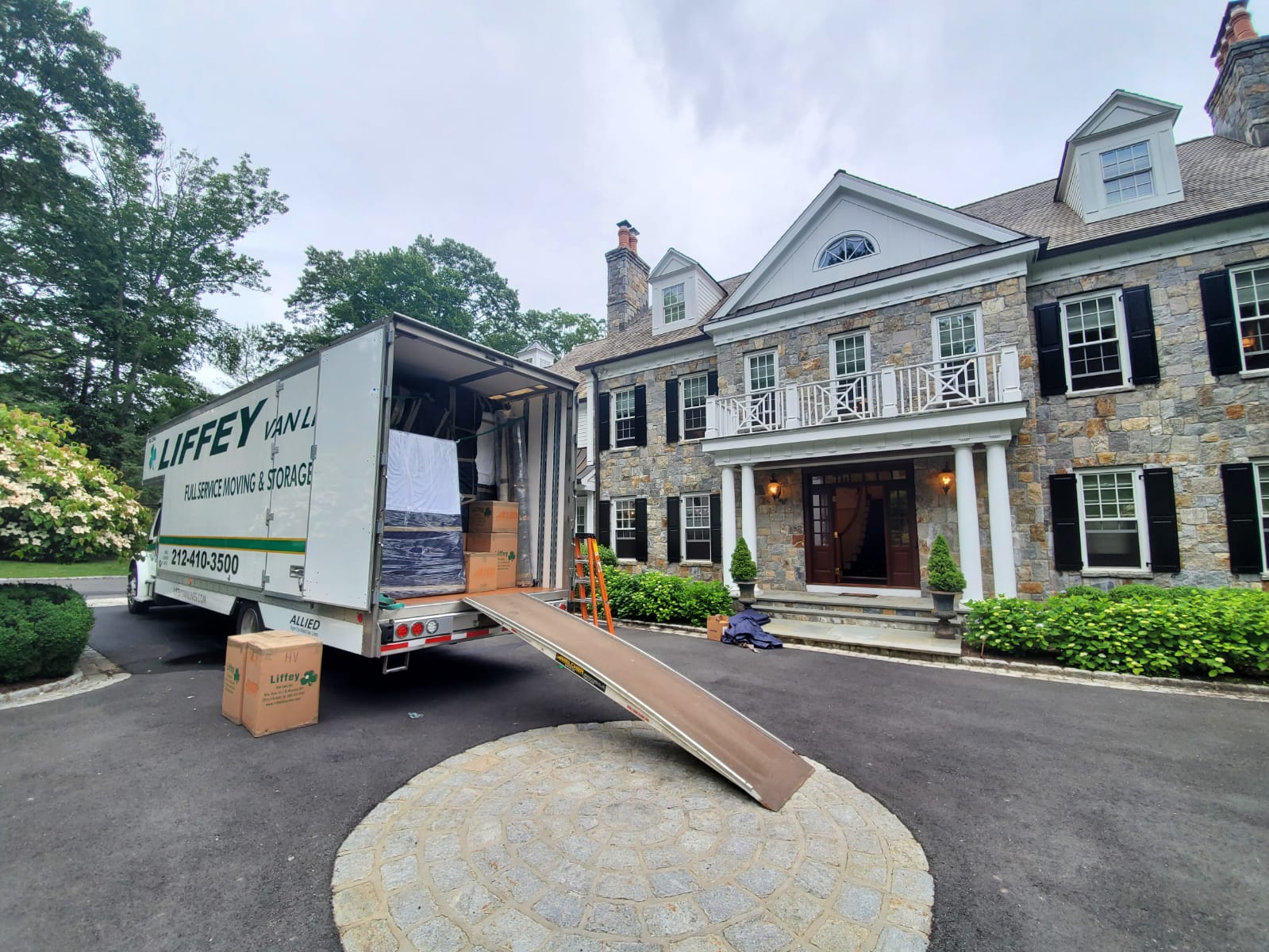 Liffey residential moving truck with ramp deployed at curb for legal loading under DOT rules